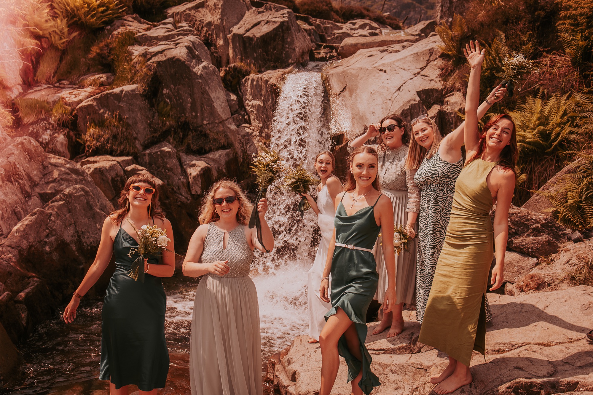 Bride and Bridesmaids at waterfalls edge in the Coppermines valley, Coniston