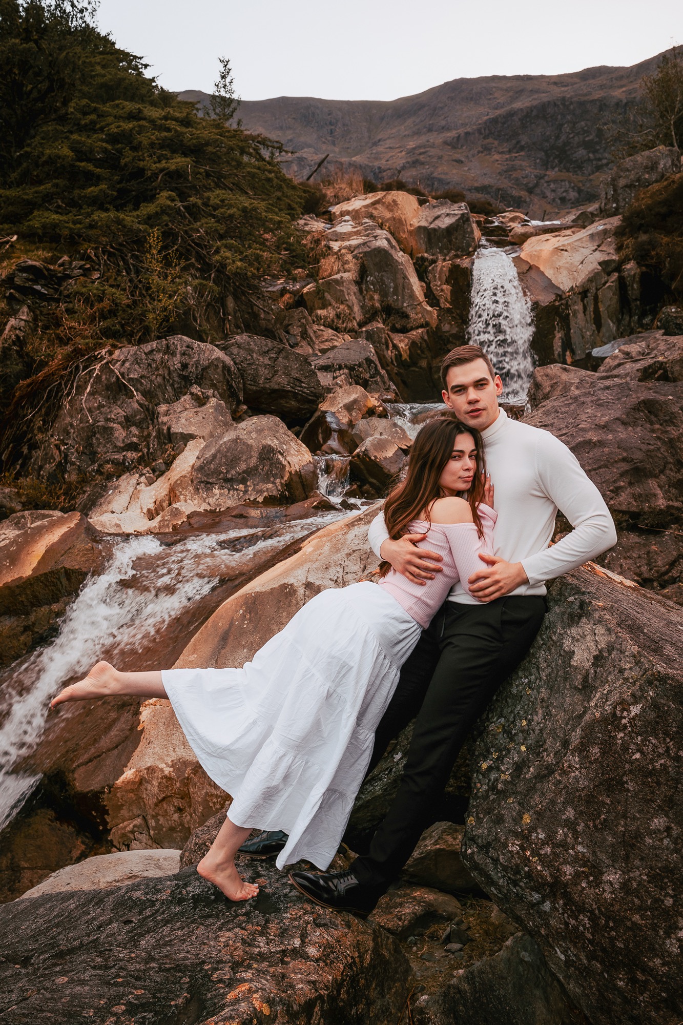 couple embrace near waterfall at Coniston