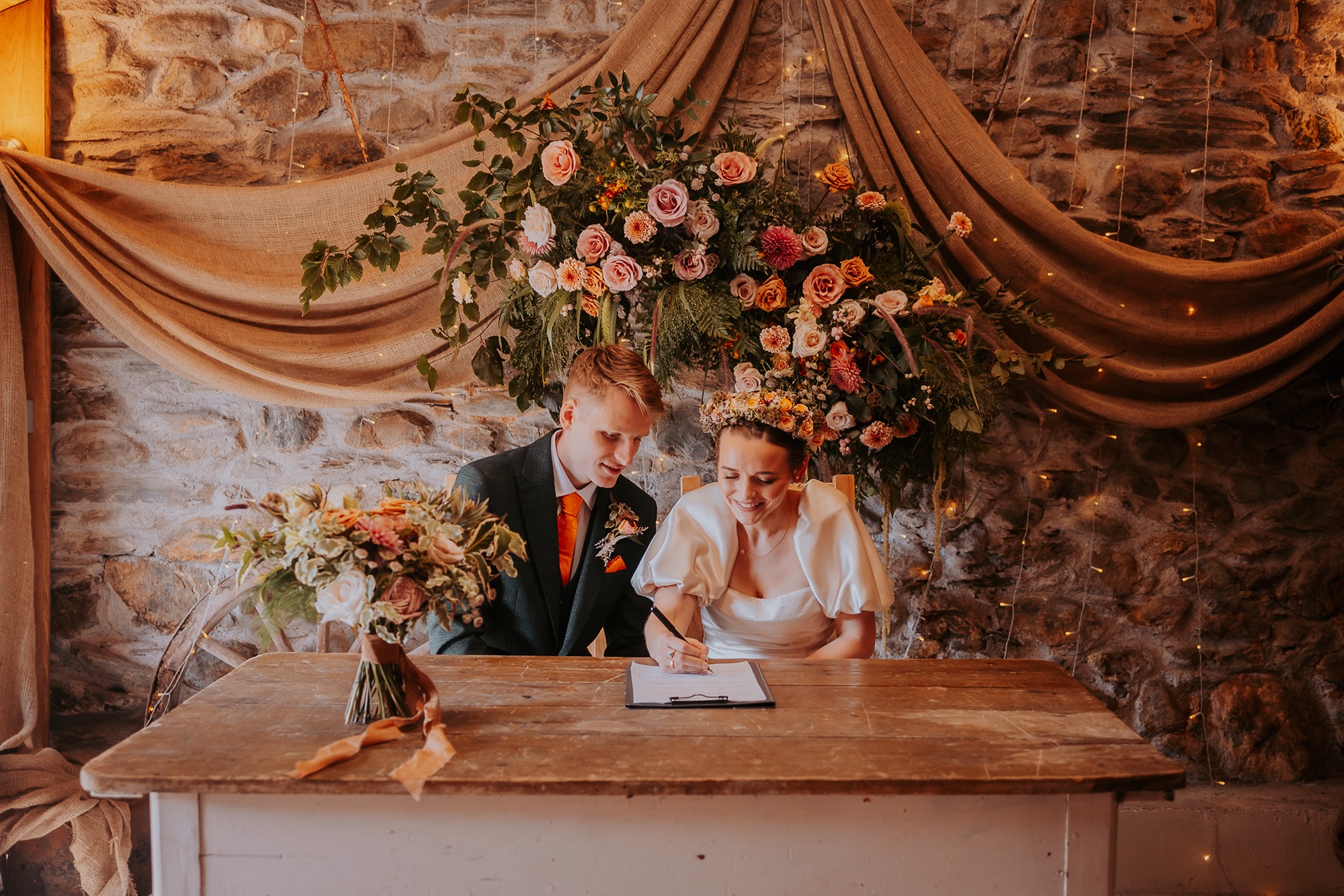 Bride and Groom signing legal papers in the wedding barn at Coppermines Mountain Weddings