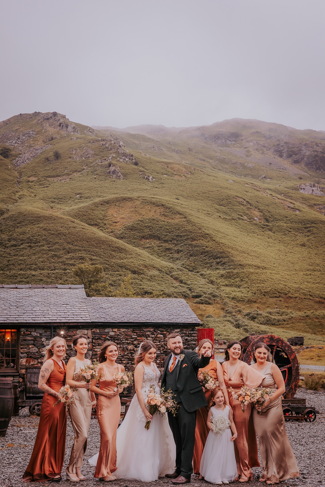 Bridesmaids and bride and groom casually chatting between formal photographs