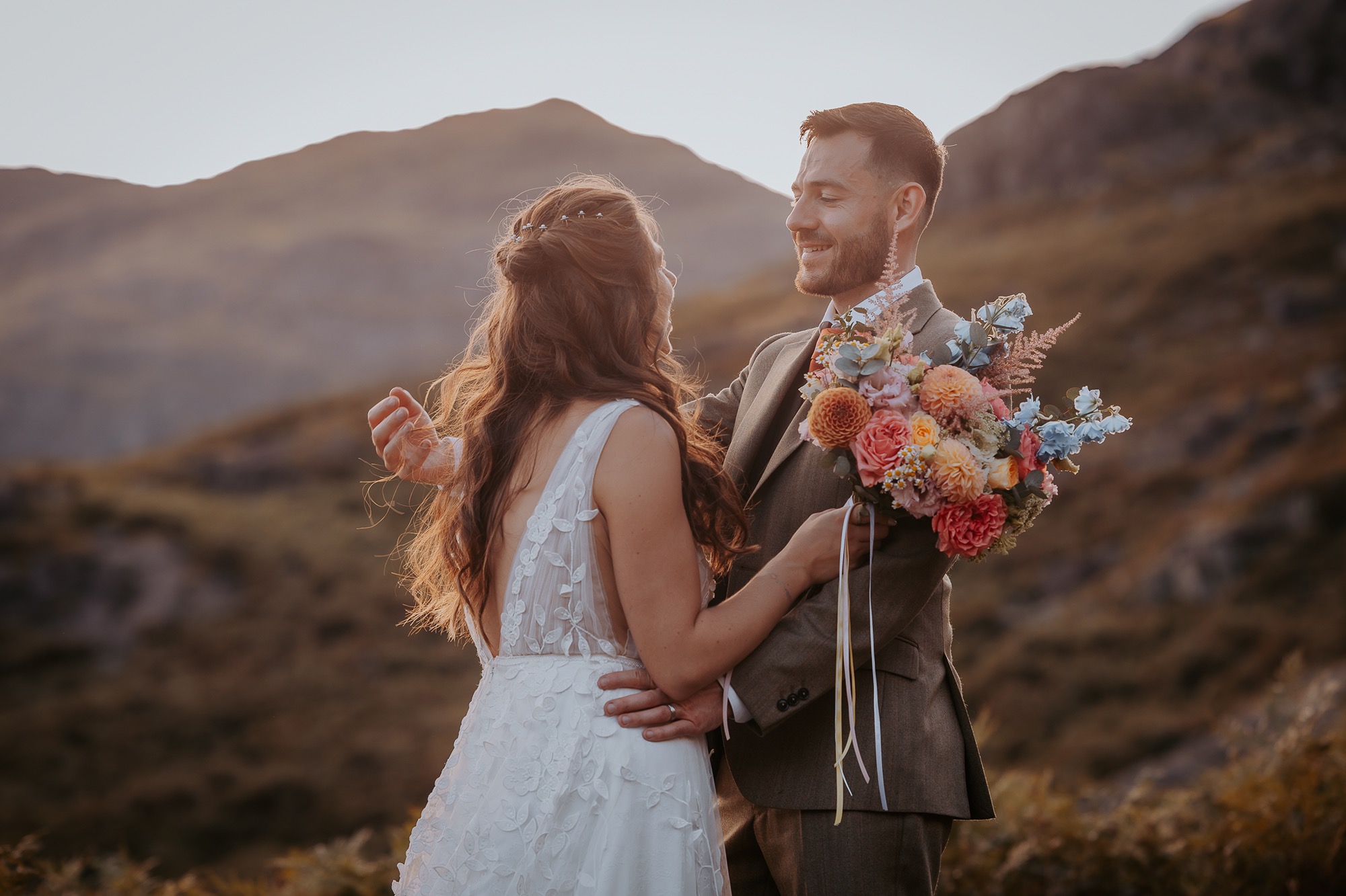 Beautiful Bluebell and Ivy bridal bouquet in brides hand during couple portraits at Coniston