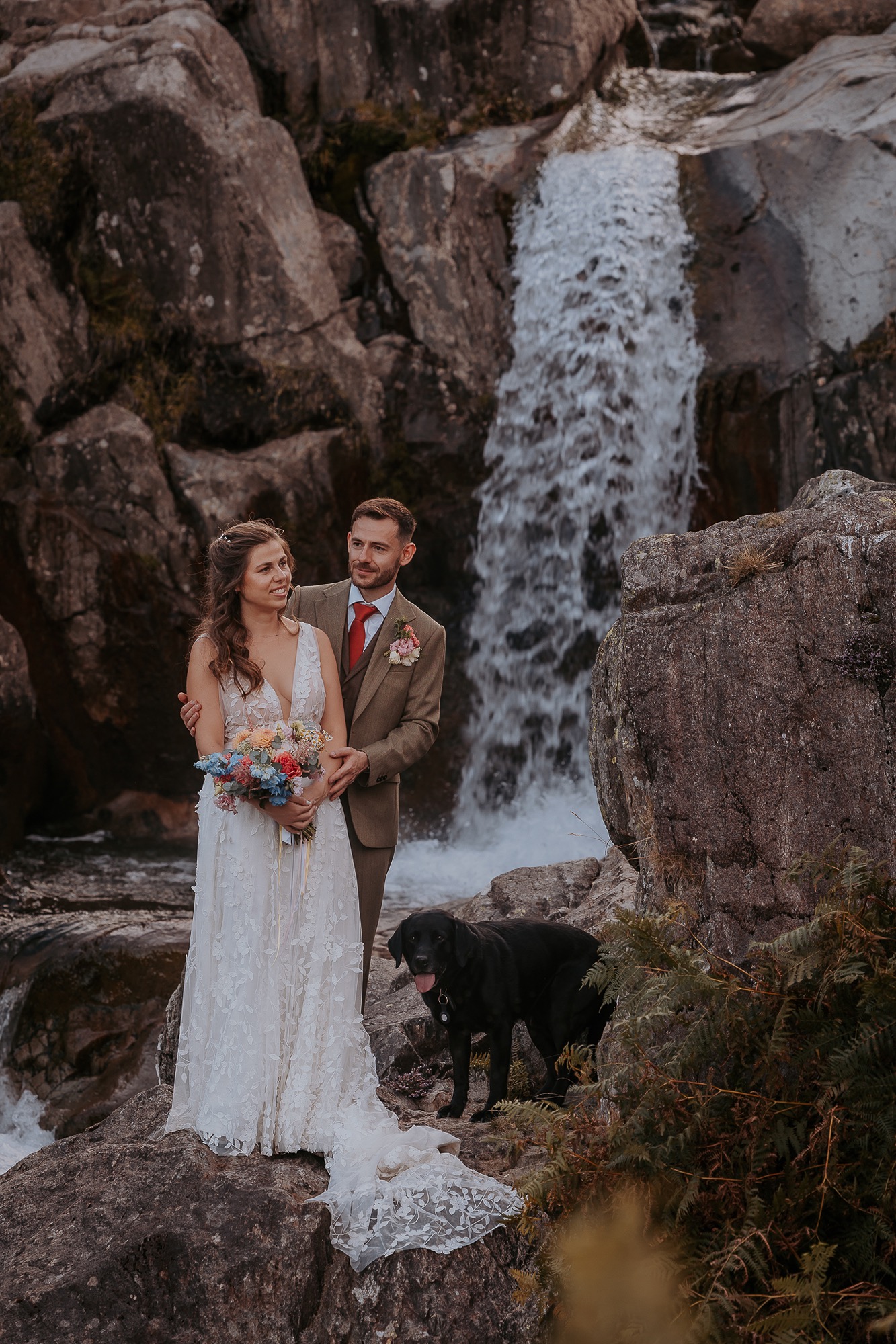 Bride and Groom enjoy a quite moment near Lake District Waterfall in the Coppermines Valley