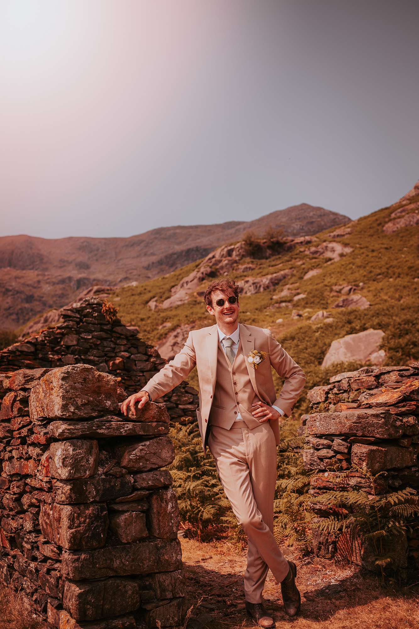 Groom stands taking in the Wainwrights surrounding him at Coniston