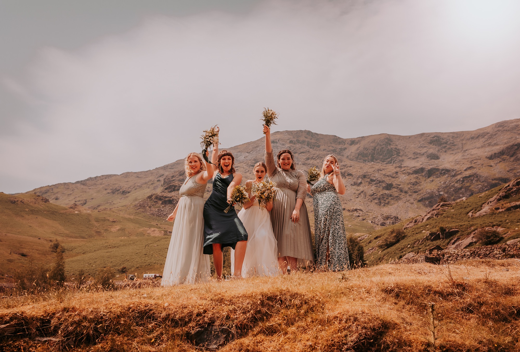 Bridal party pose having fun in the Coppermines Valley, Coniston