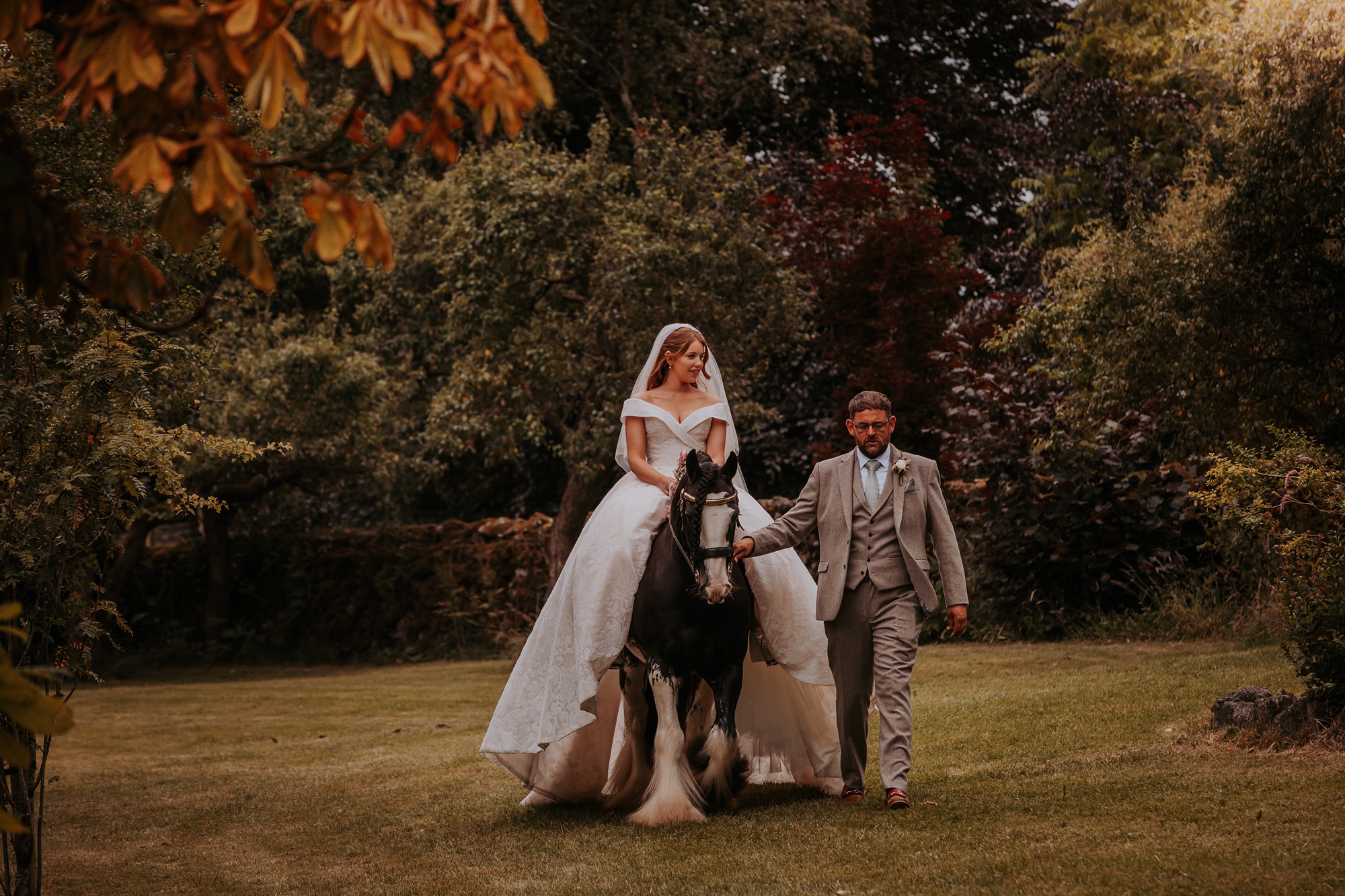 bride walks down aisle on horseback at her countryside wedding in North Yorkshire