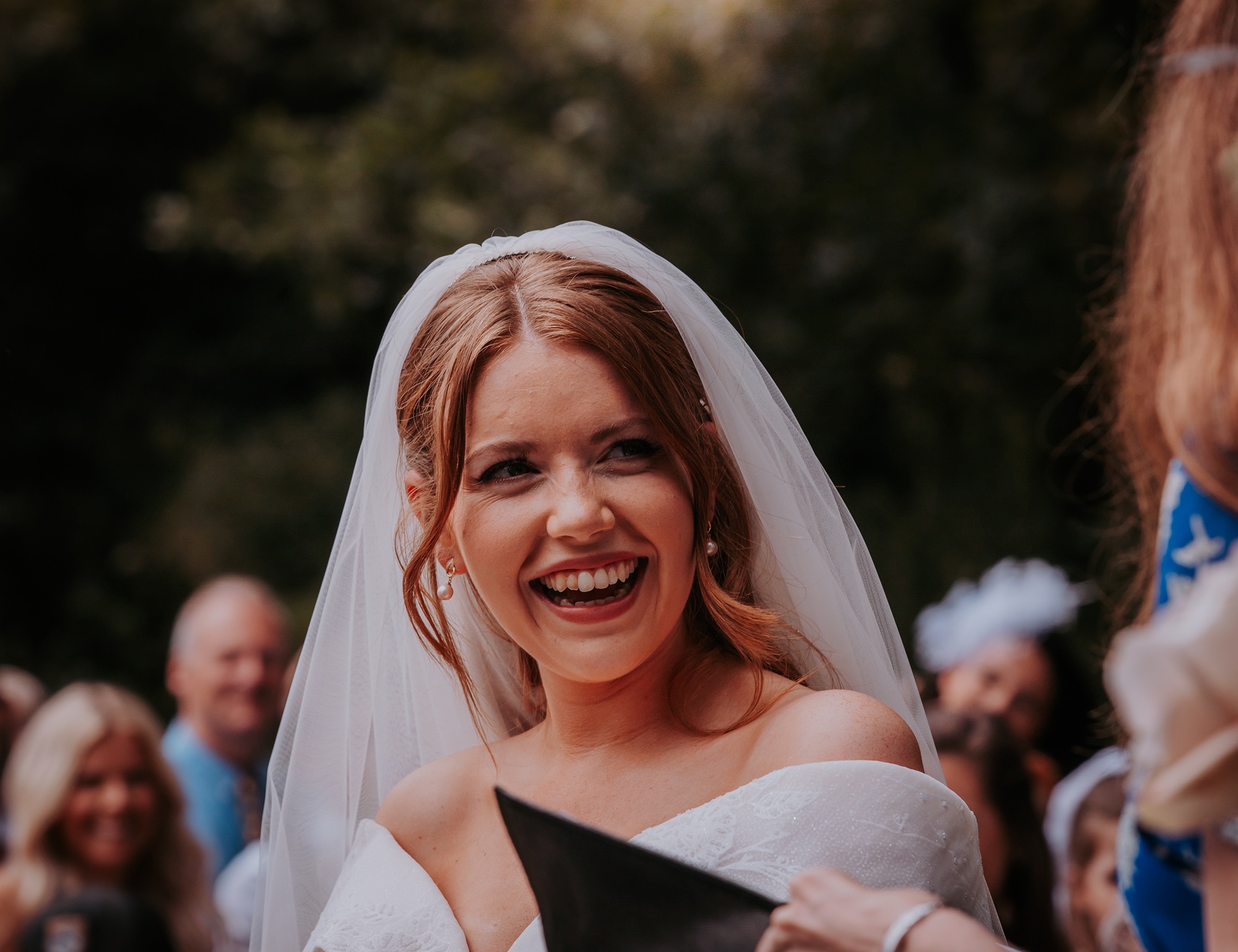 bride smiling naturally as she says her vows to her husband