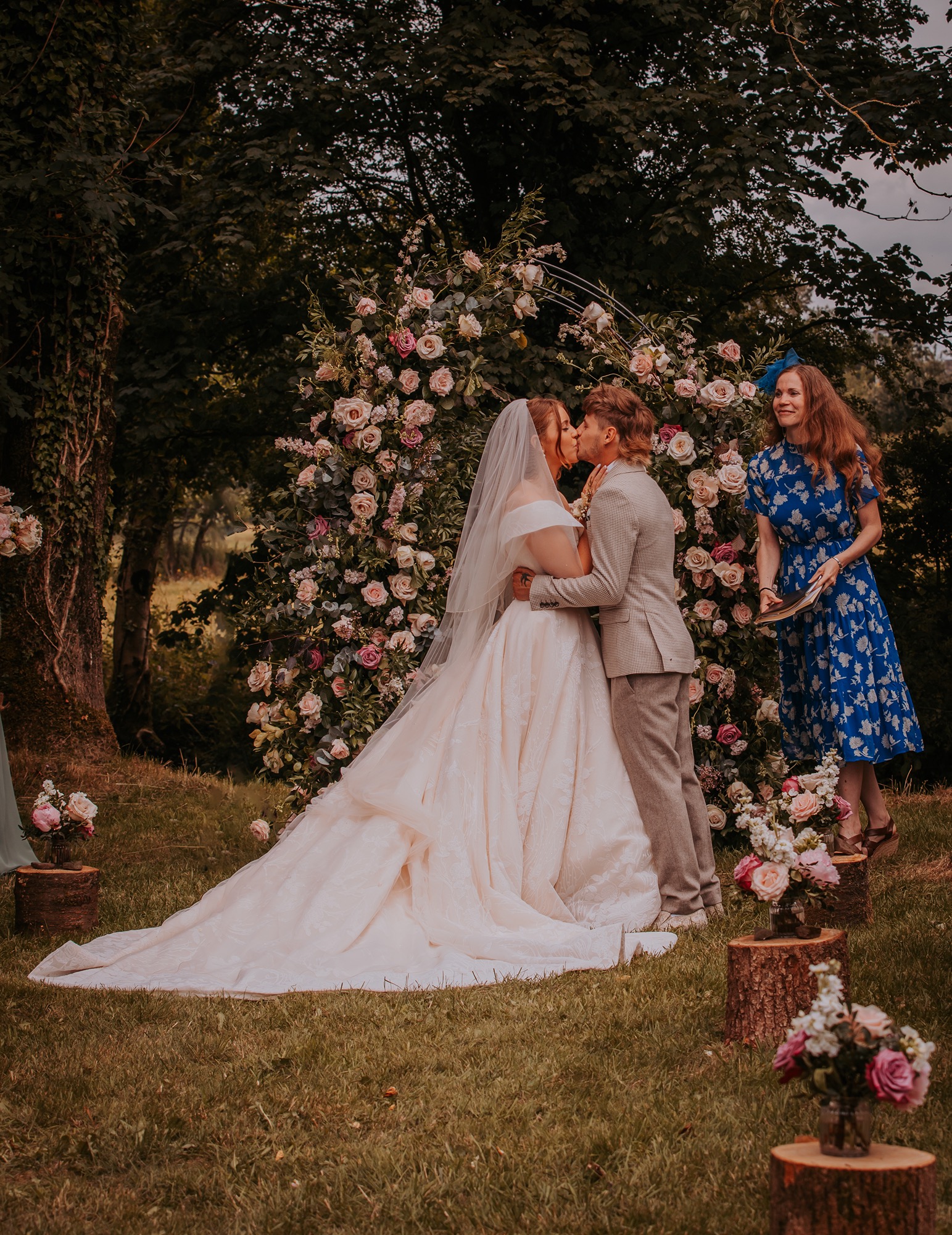 Bride and grooms first kiss at farm wedding in open paddock