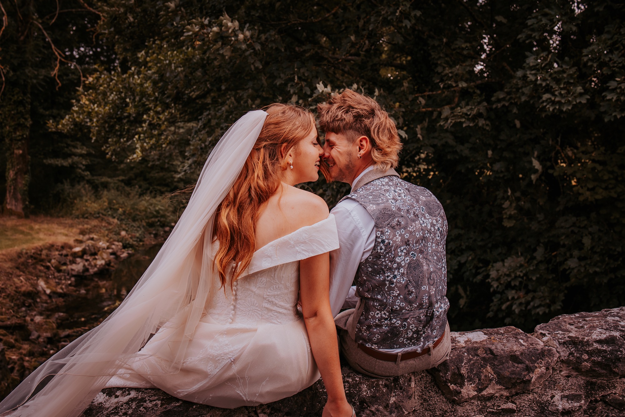 bride and groom enjoy a quiet moment on a bridge