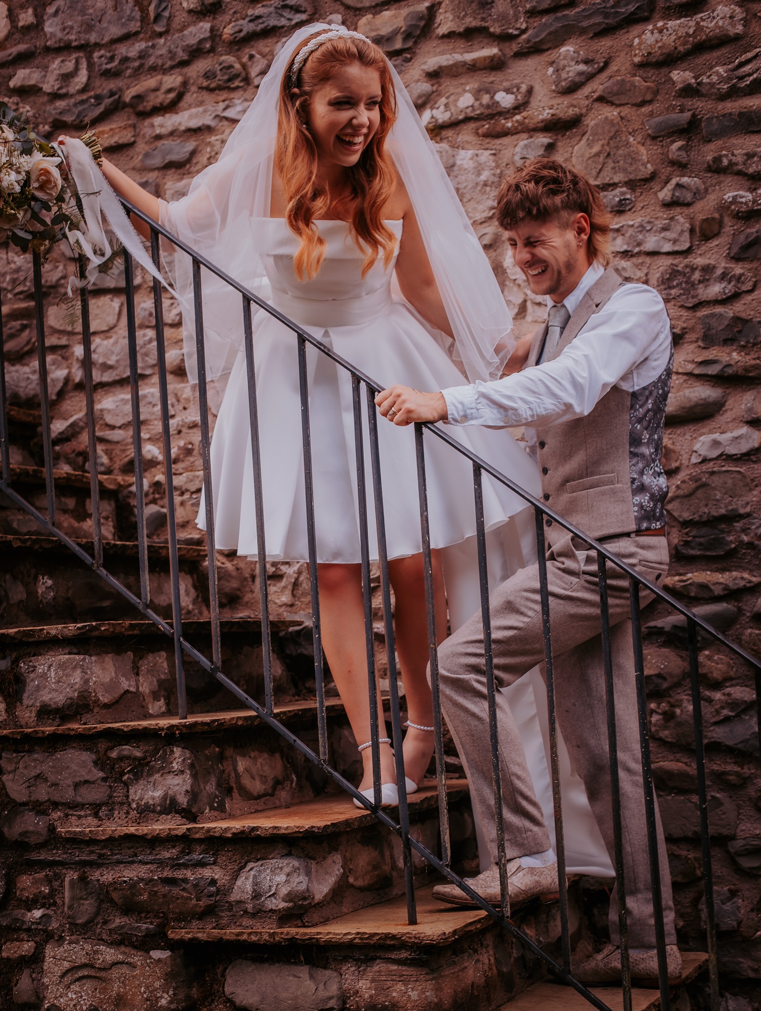 bride and groom walk up stairs