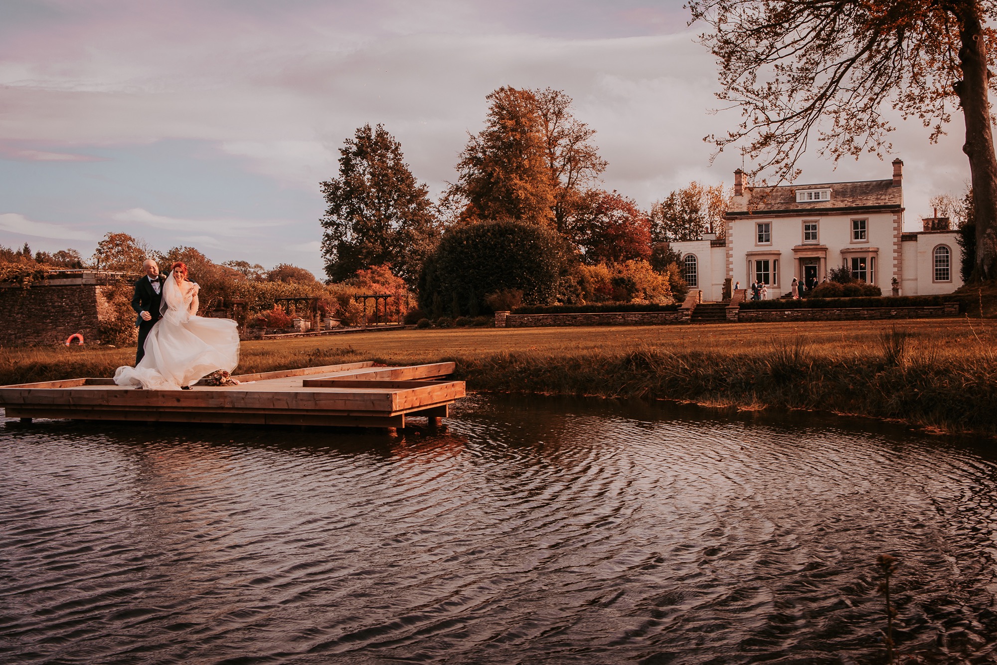 Bride and groom dance in the jetty outside Holesfoot house