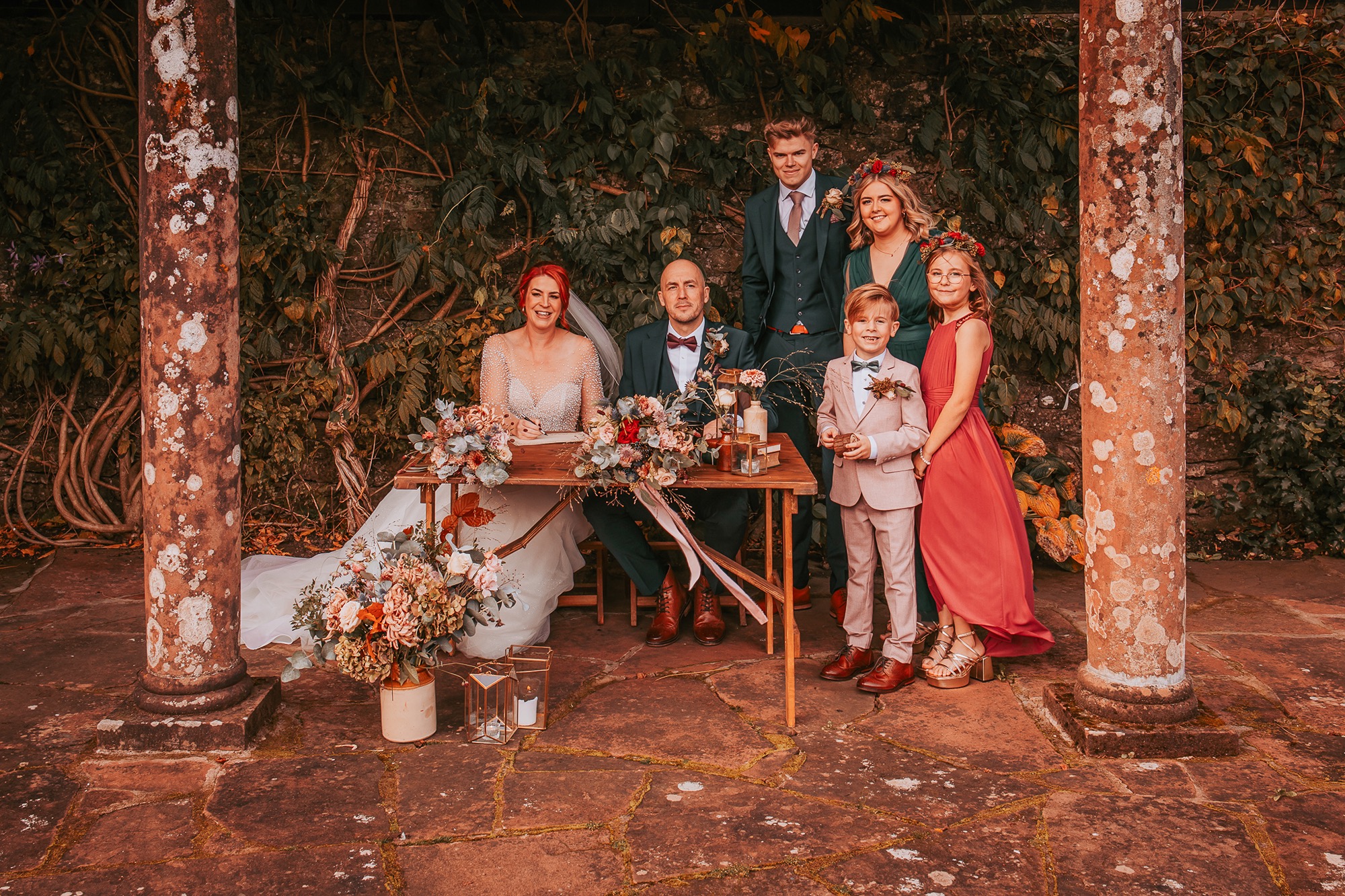 blended family at signing of register in Holesfoot garden ceremony
