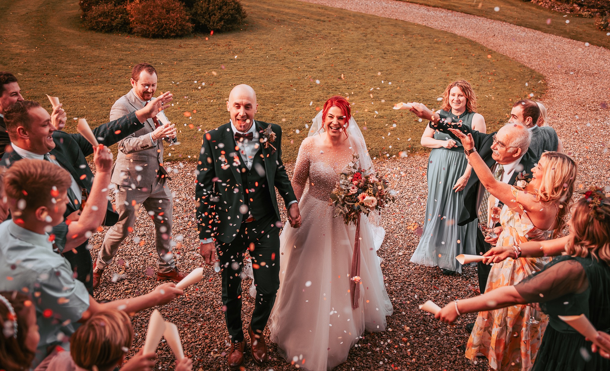 Confetti being thrown over bride and groom at Holesfoot