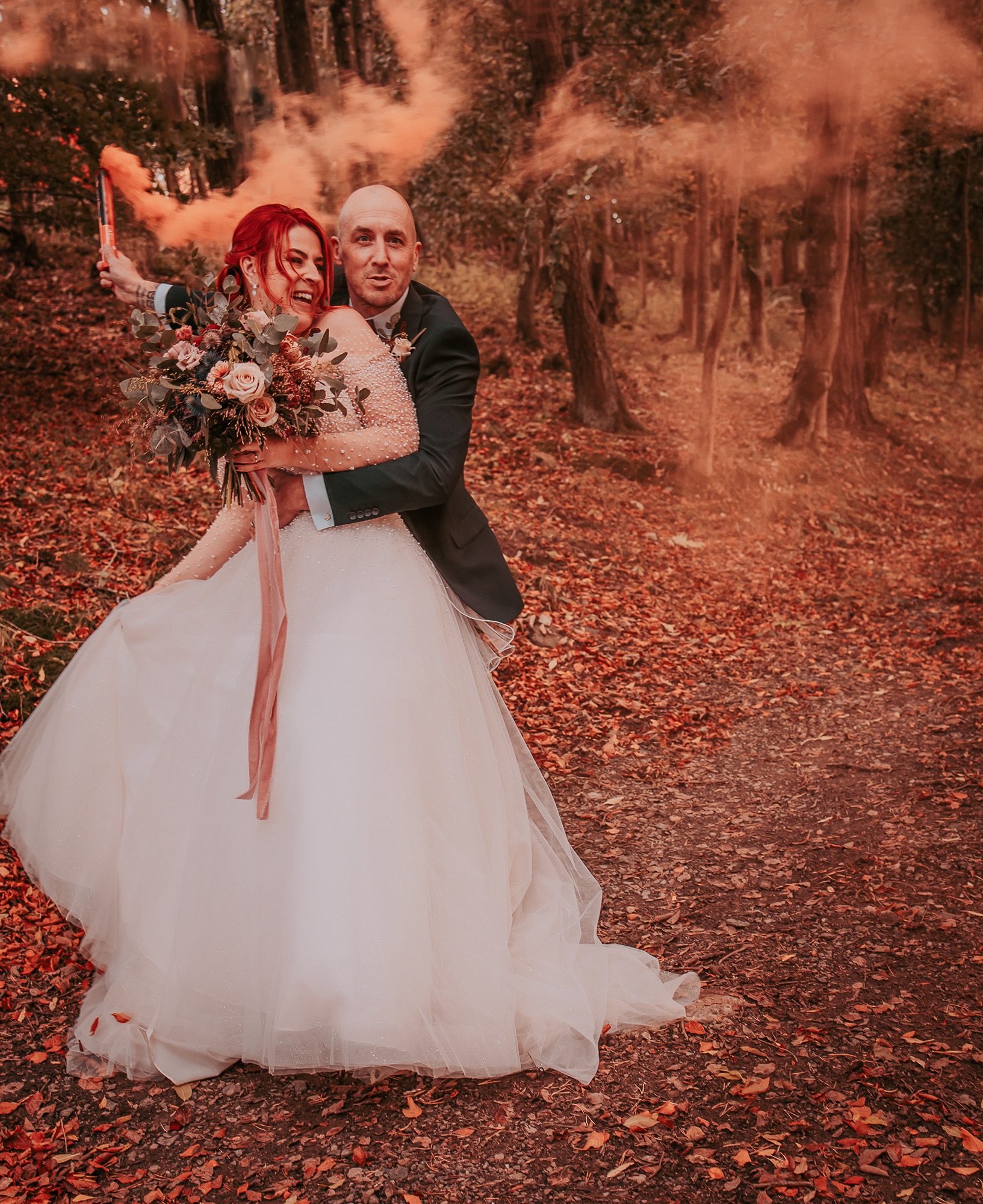 Bride and gore dance and laugh with orange smoke grenade, Hoelsfoot, Penrith