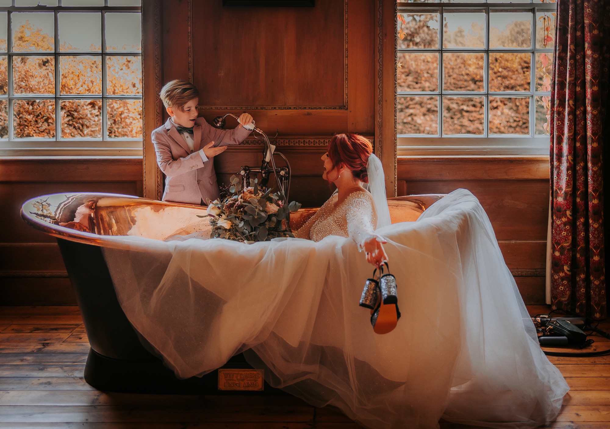 page boy, playfully splashes mum with shower ahead of wedding ceremony