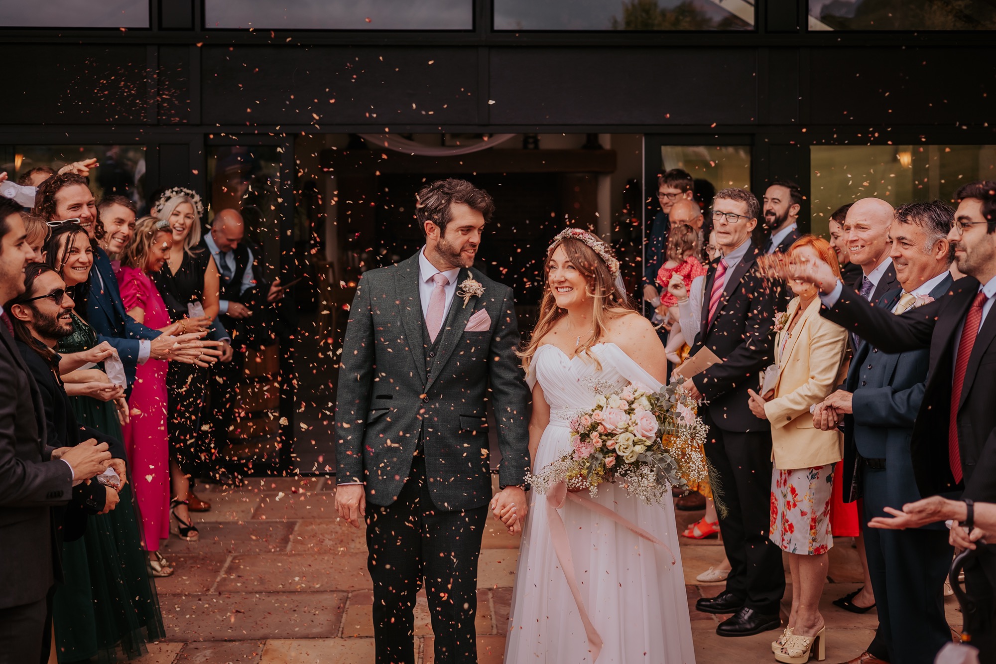 newly-weds walk through confetti at New House Farm, Lorton