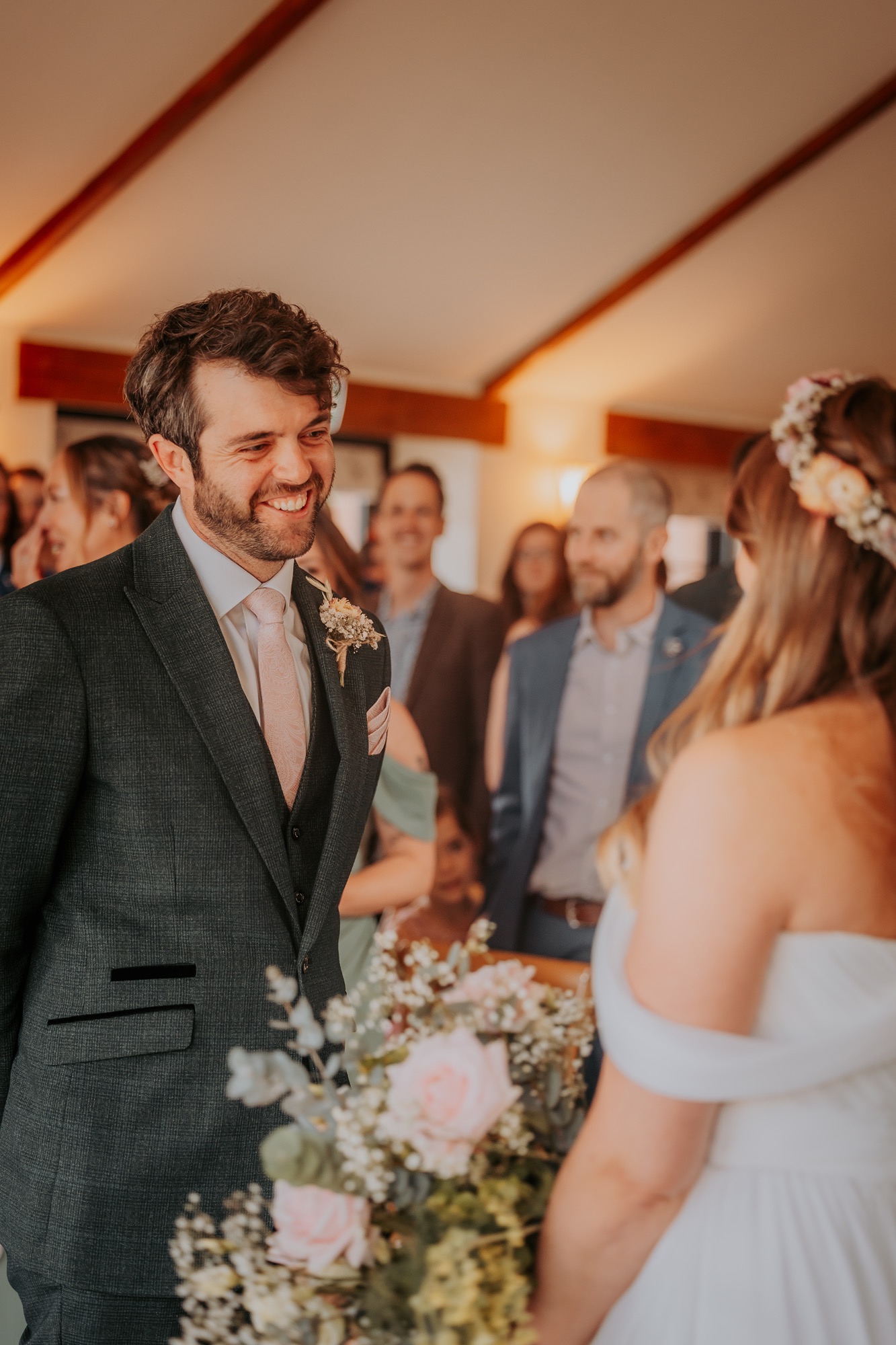 Groom smiles upon the arrival of his bride in New House Farm wedding barn