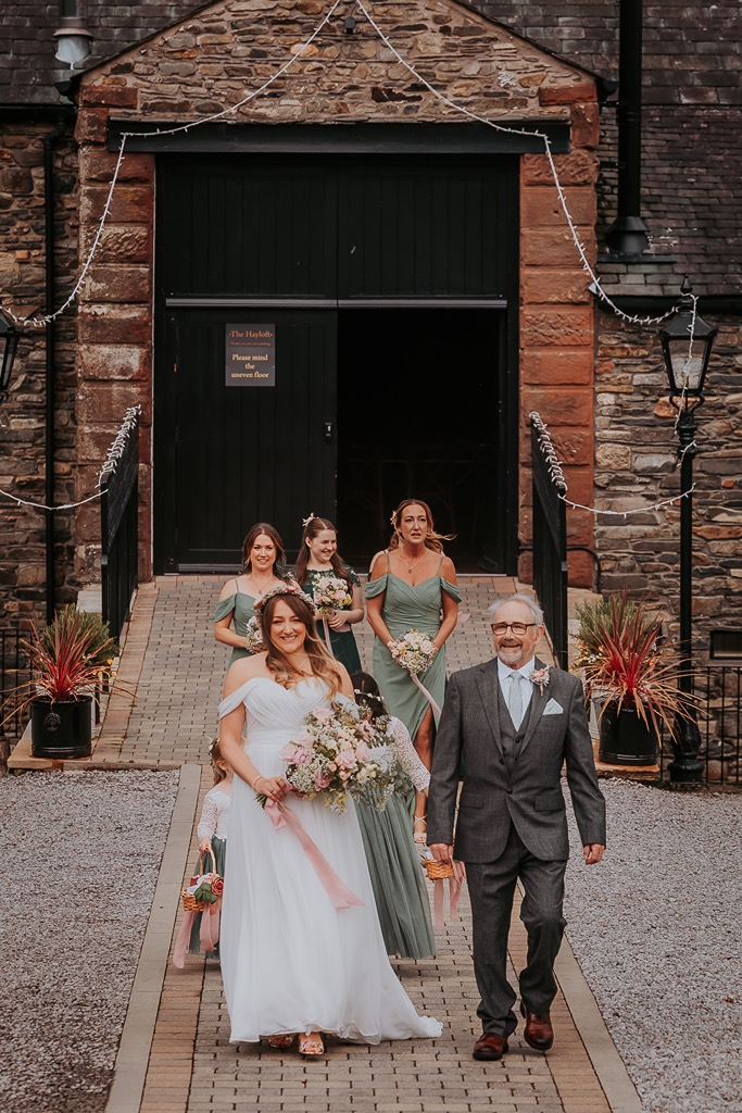 bride walking to her wedding ceremony with her father and bridal party, New House Farm, Lorton