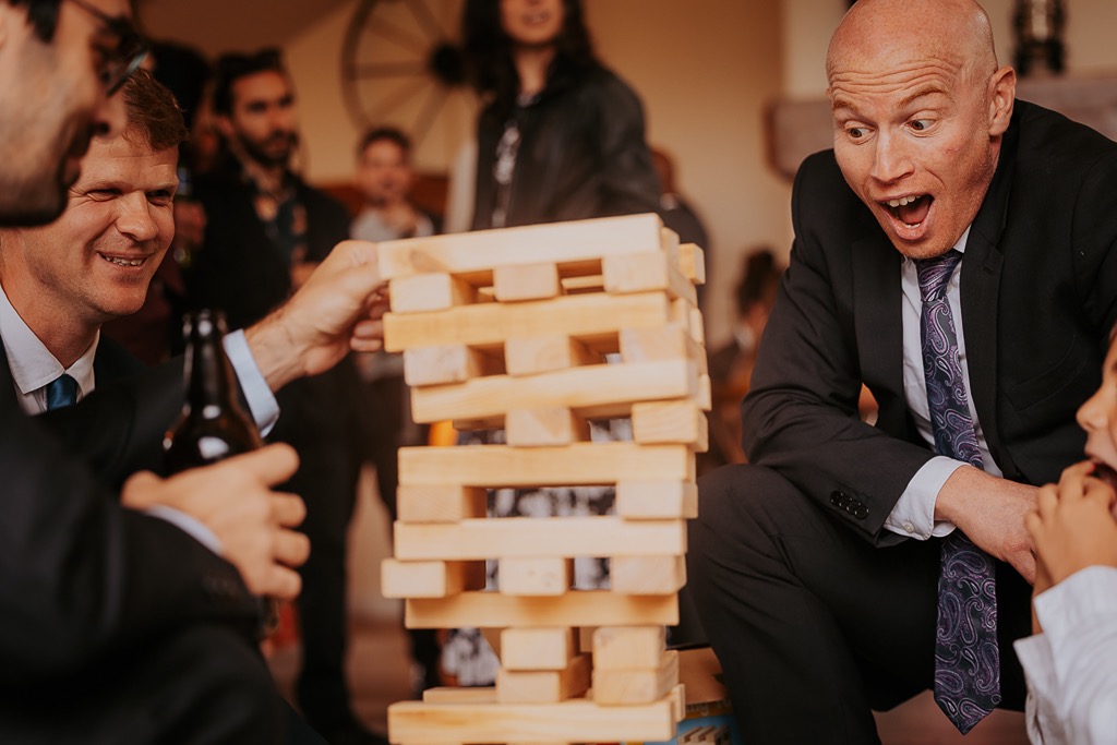 wedding guests play giant jingo with the children at wedding reception