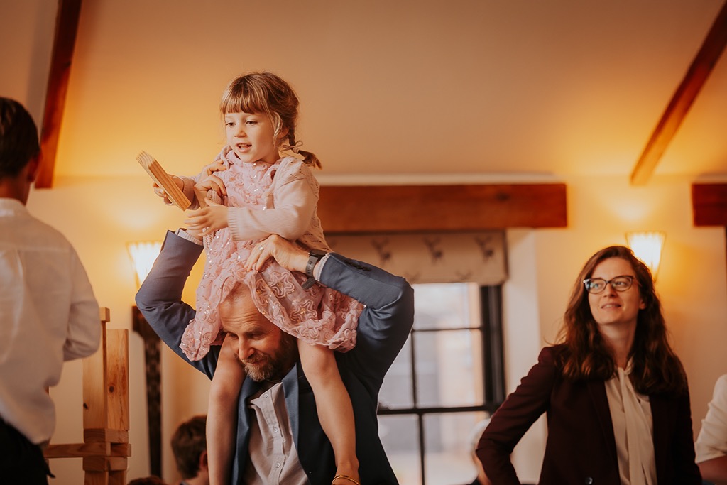 wedding guest helps little girl build benga castle at New House Farm