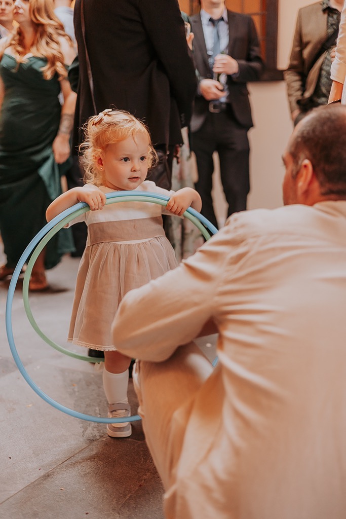 little girl plays with halo-hoops at wedding receptions at New House Farm, Cumbria