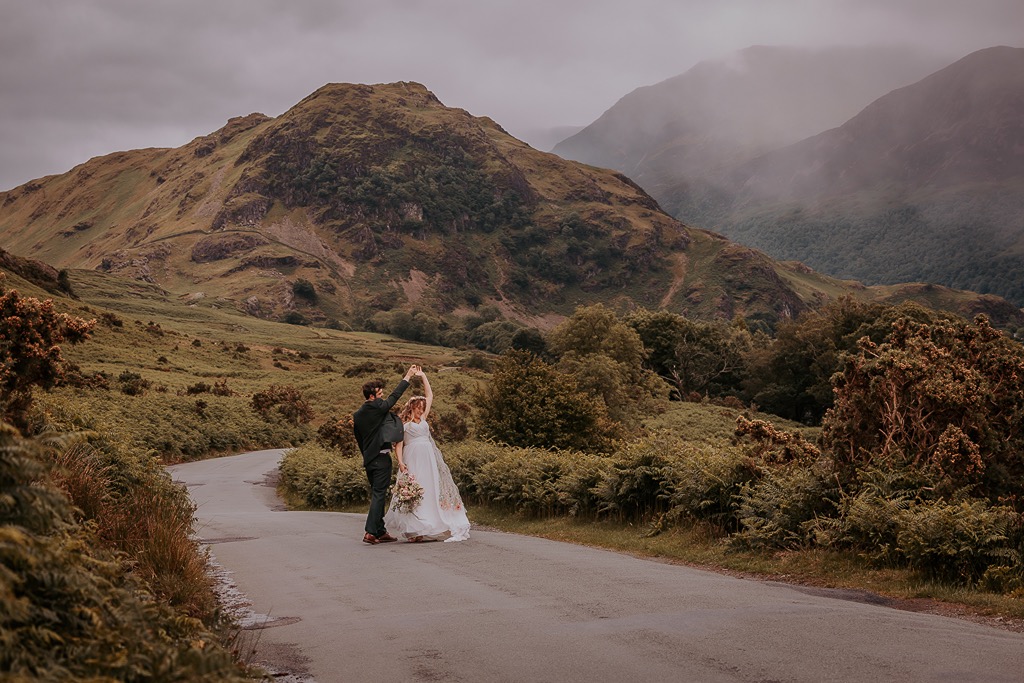 bride and groom dance on the road near stickle pike