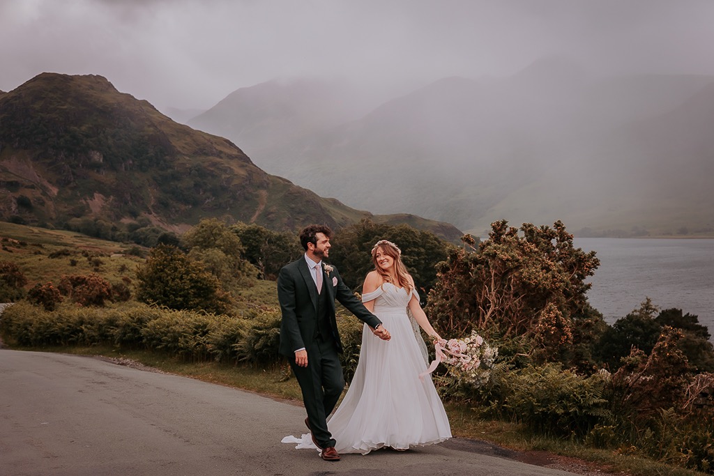 bride and groom walk near Crummock water, The Lake District