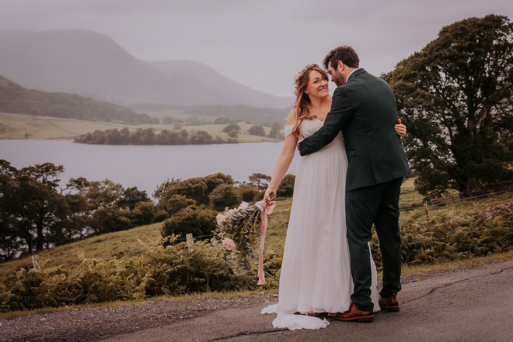 newly-weds giggle during intimate moment at Crummock water, Cumbria
