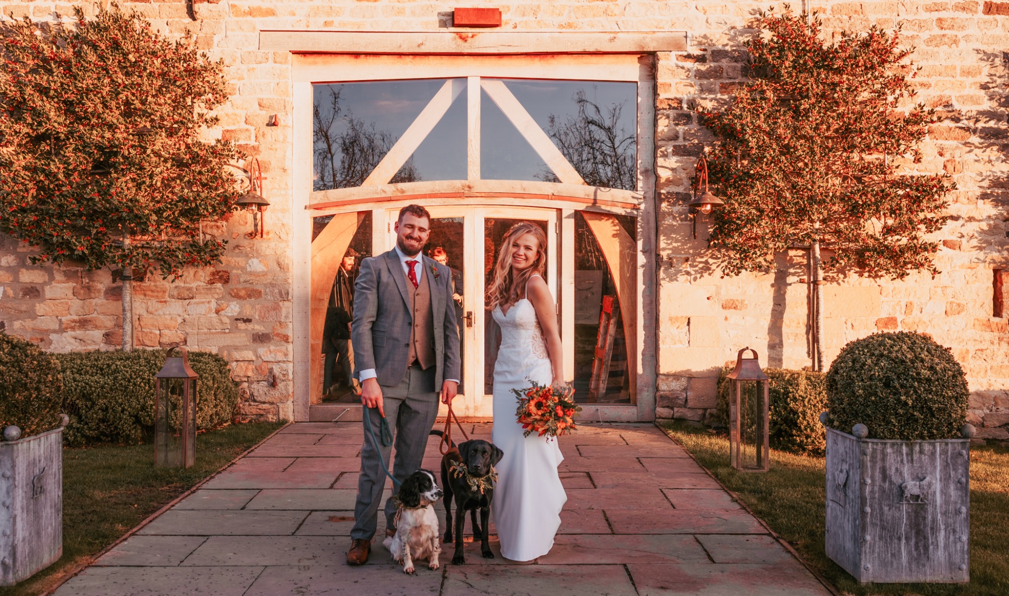 Bride and groom with their dogs outside Healey Barn, Yorkshire