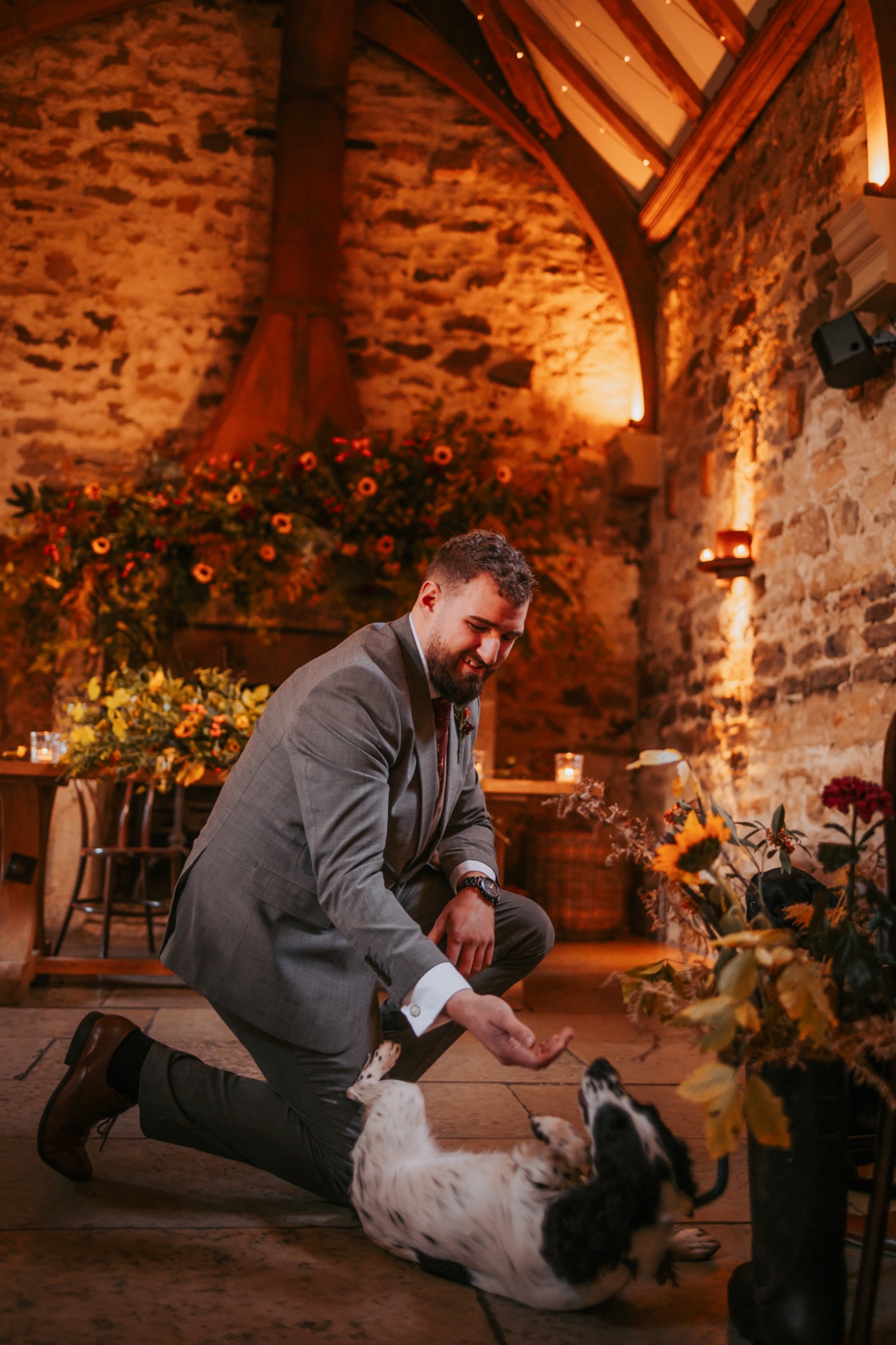 Excited working dog meets groom at the top of the aisle at Healey Barn, Yorkshire