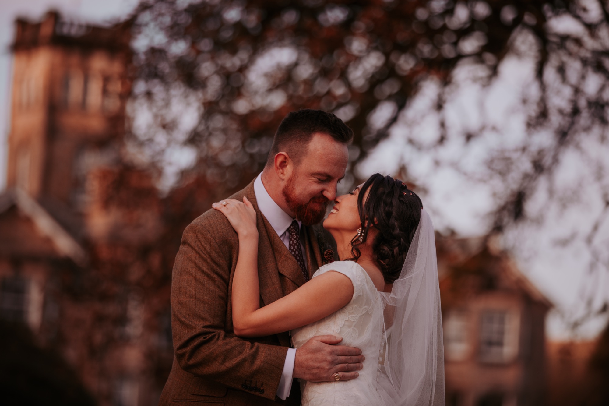 Bride and groom ready to kiss outside, Auchen Castle, Moffat, Scotland