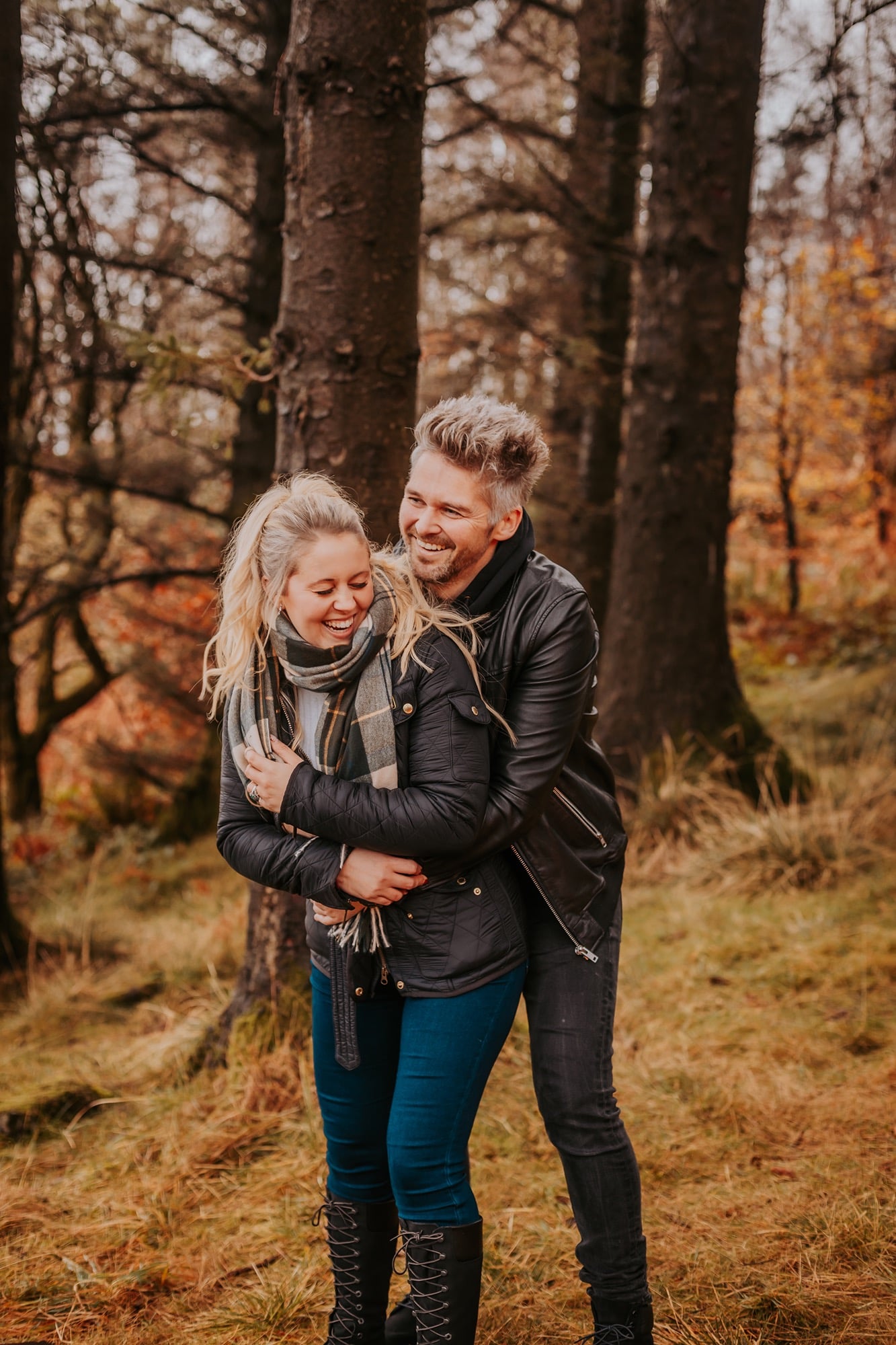 Couple enjoy a fun pre-wedding portrait, at Gummer How, Windermere