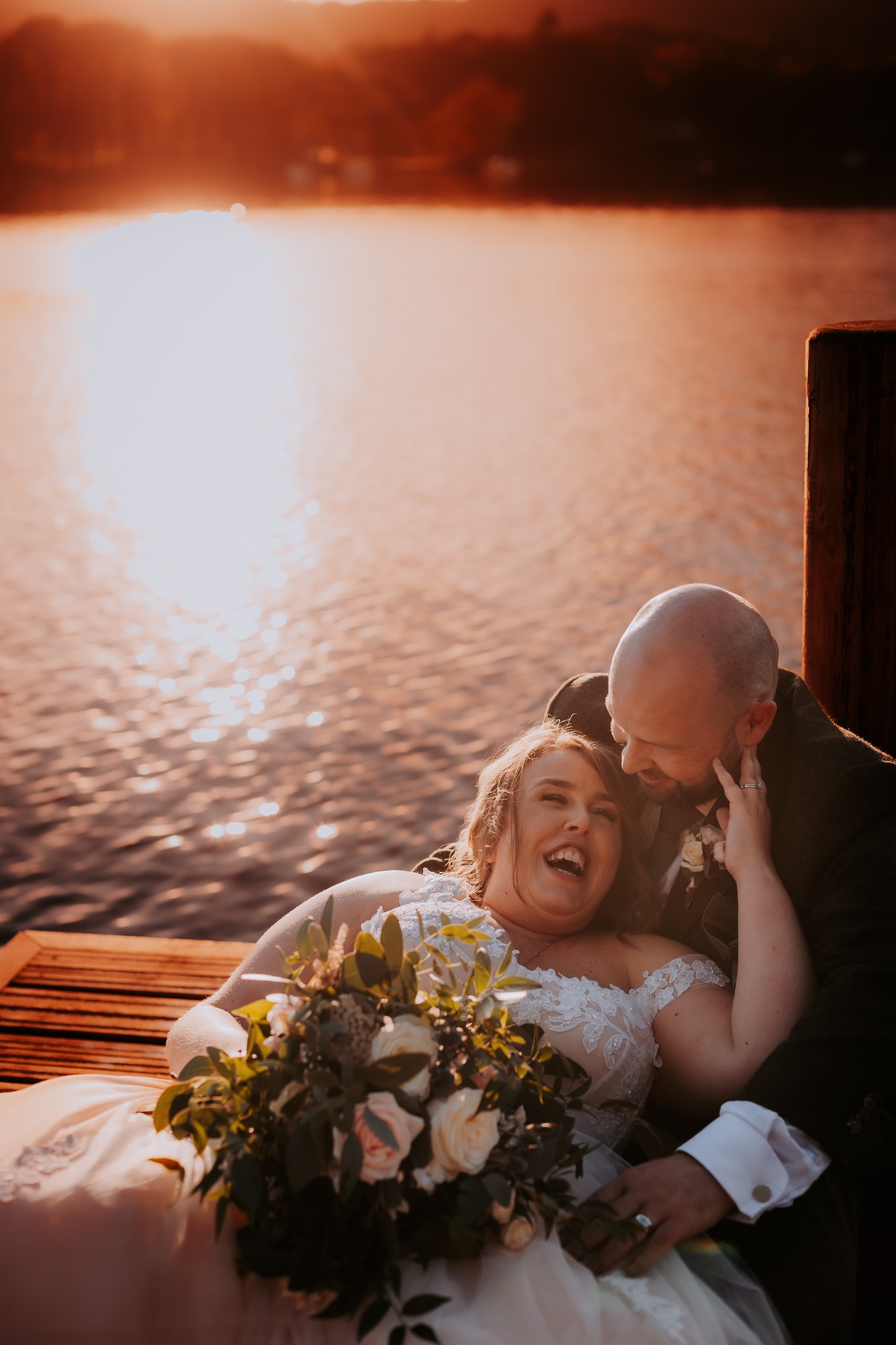 Bride and groom romance at sunset on the private jetty, Town Head Estate