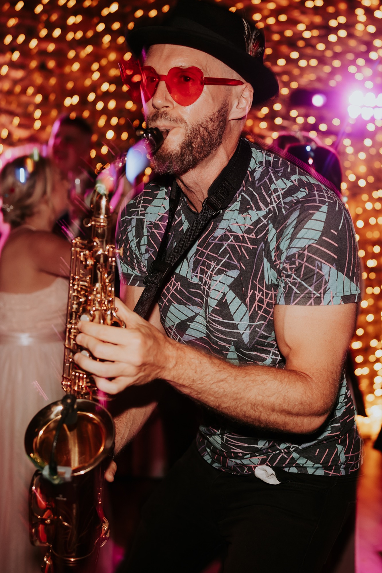 Wedding saxophonist playing during the evening celebrations