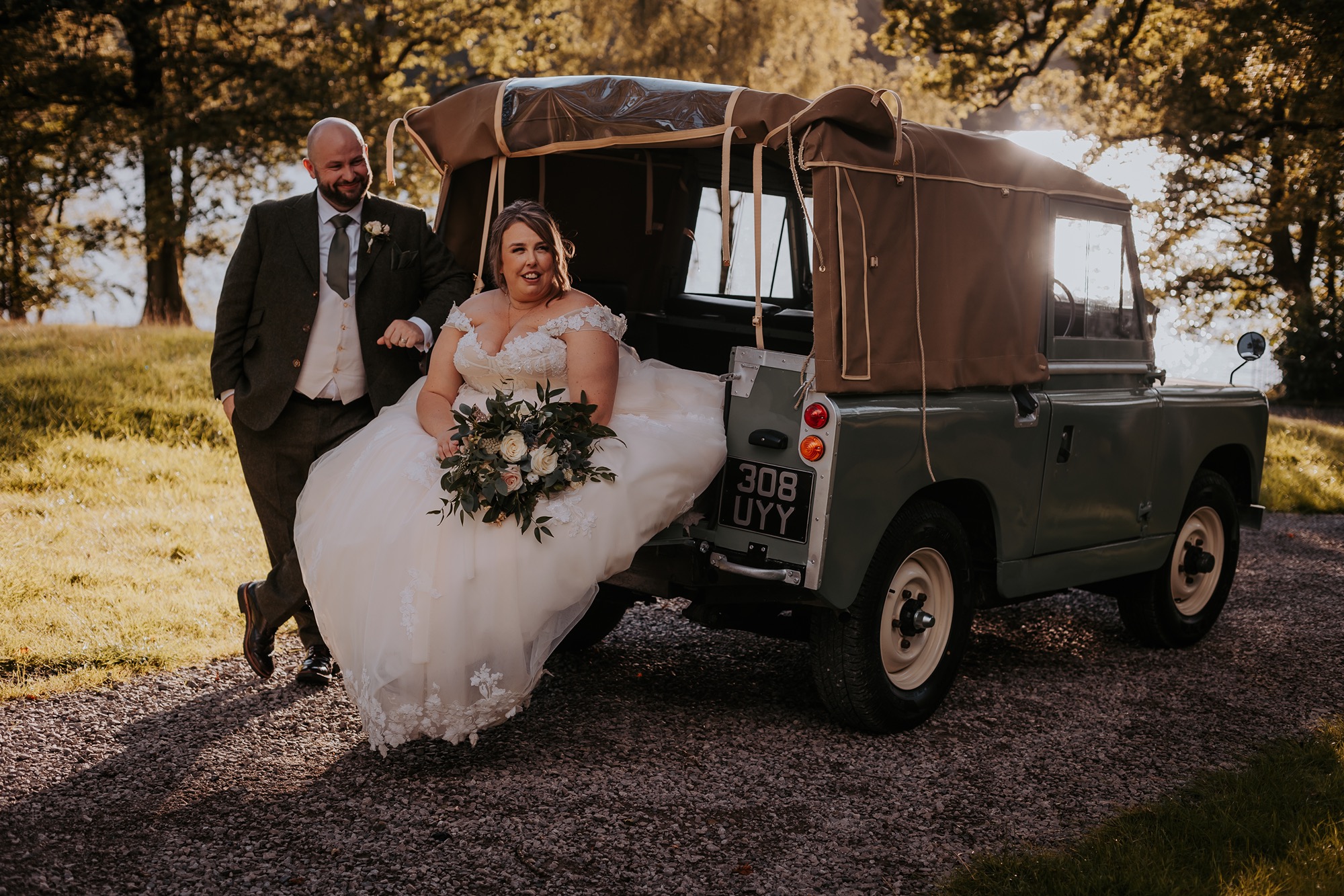 Newly-weds enjoying a sit down in back of landrover