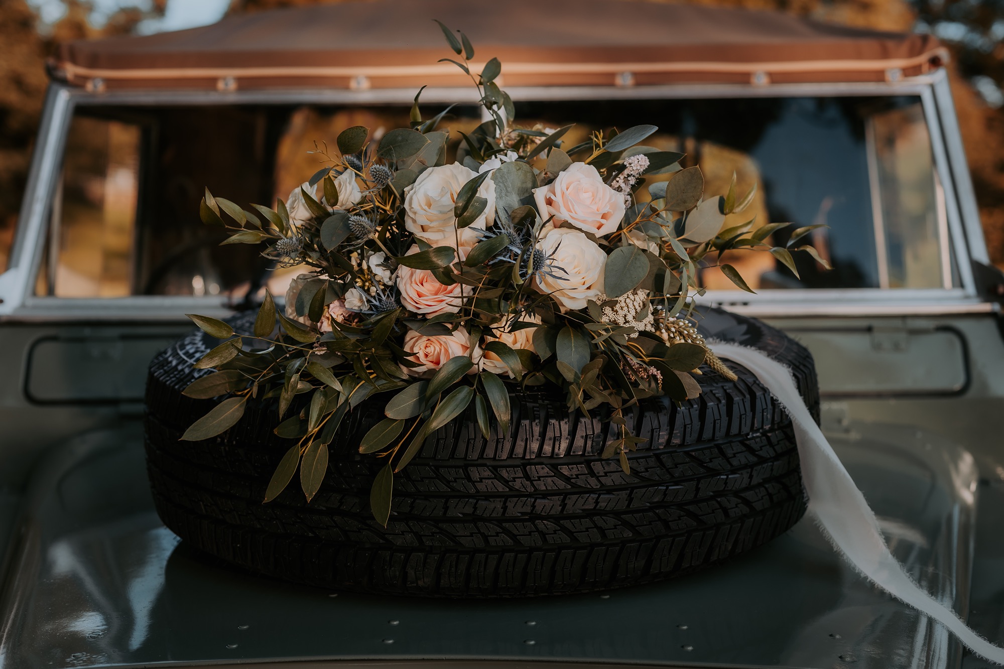 Bridal bouquet on the bonnet of Landrover