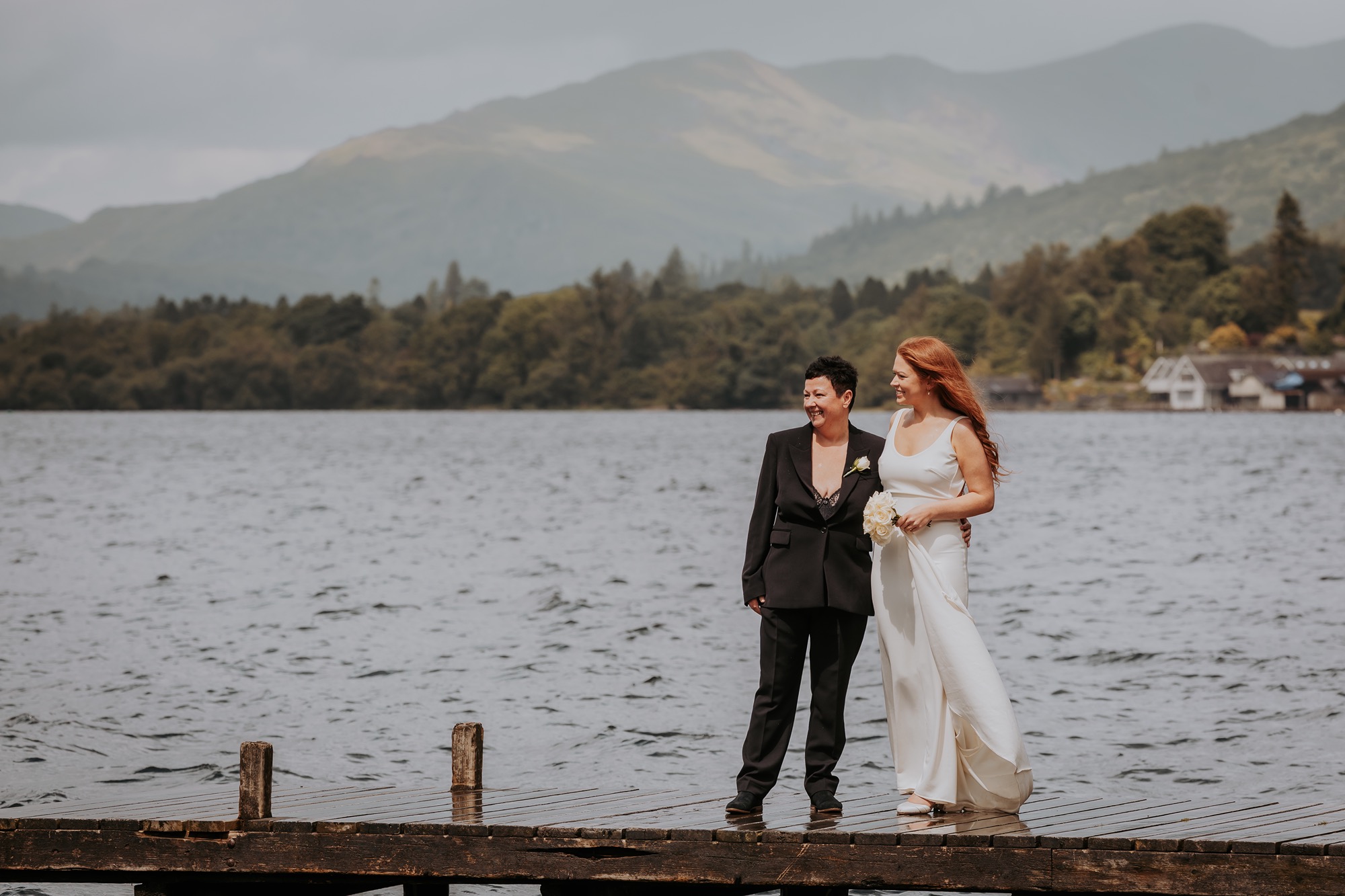 Lake District LGBTQ - same sex wedding couple celebrating with confetti and saxophonist 