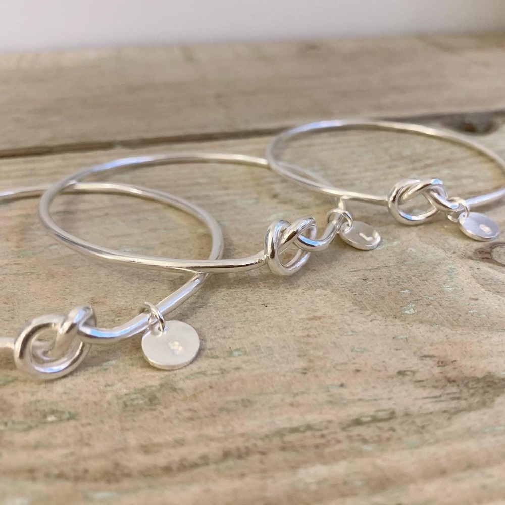 Silver knot bangle with initial disc 