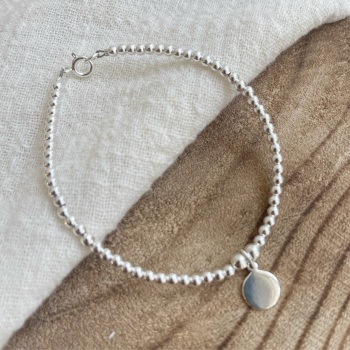 Beaded sterling silver bracelet with disc charm