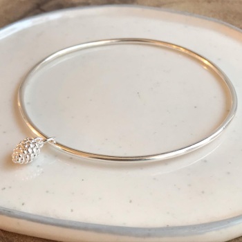 A. Round bangle with pinecone charm