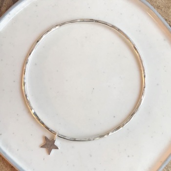 A. Round hammered bangle with star charm