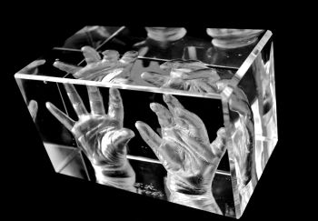 Pair of baby hands in glass 3d cube