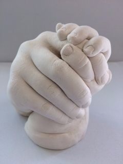 Sibling holding hands in plaster 