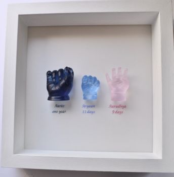 Trio of glass hands framed