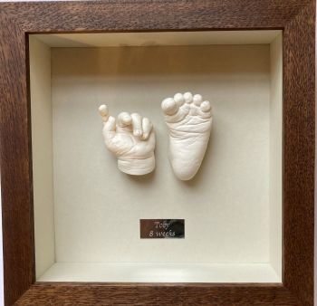 Plaster 3D baby hand and foot  framed in walnut oak frame.