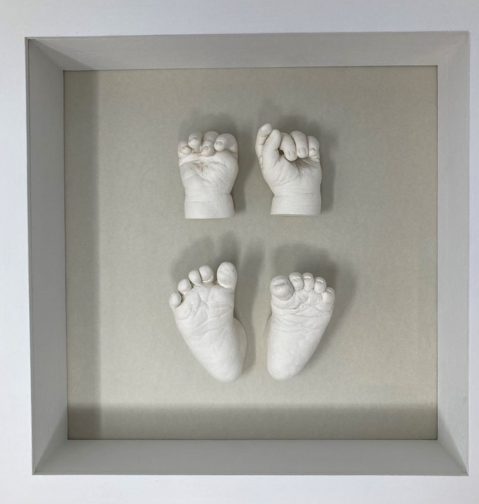 Baby hands and feet in plaster framed 