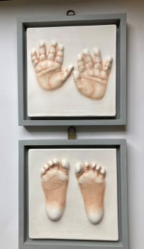 2 small baby impressions in open frame