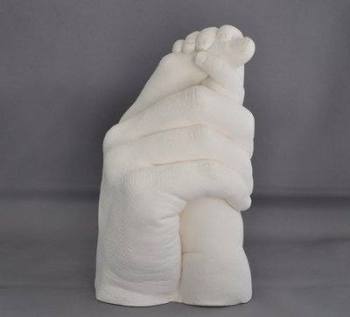 Father and baby holding hands in plaster