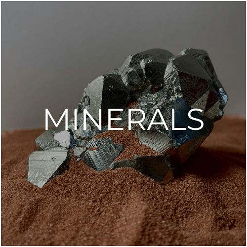 The mineral category depicted by a shiny piece of pyrite sat in red desert sand