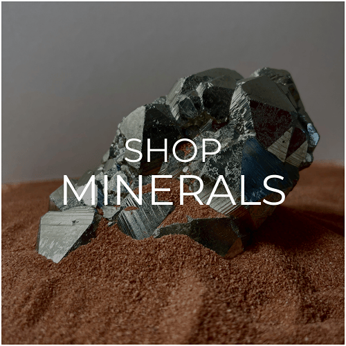 The mineral category depicted by a shiny piece of pyrite sat in red desert sand