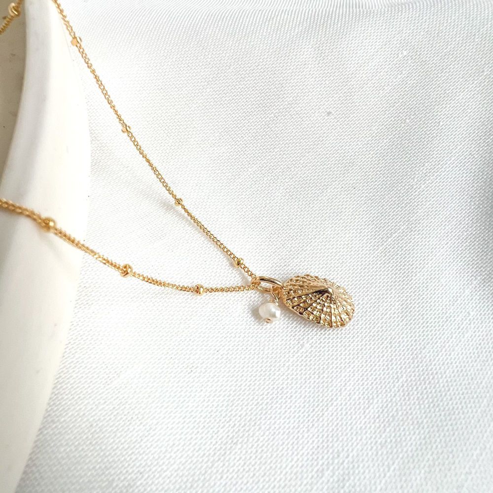 Pearl and shell charm necklace